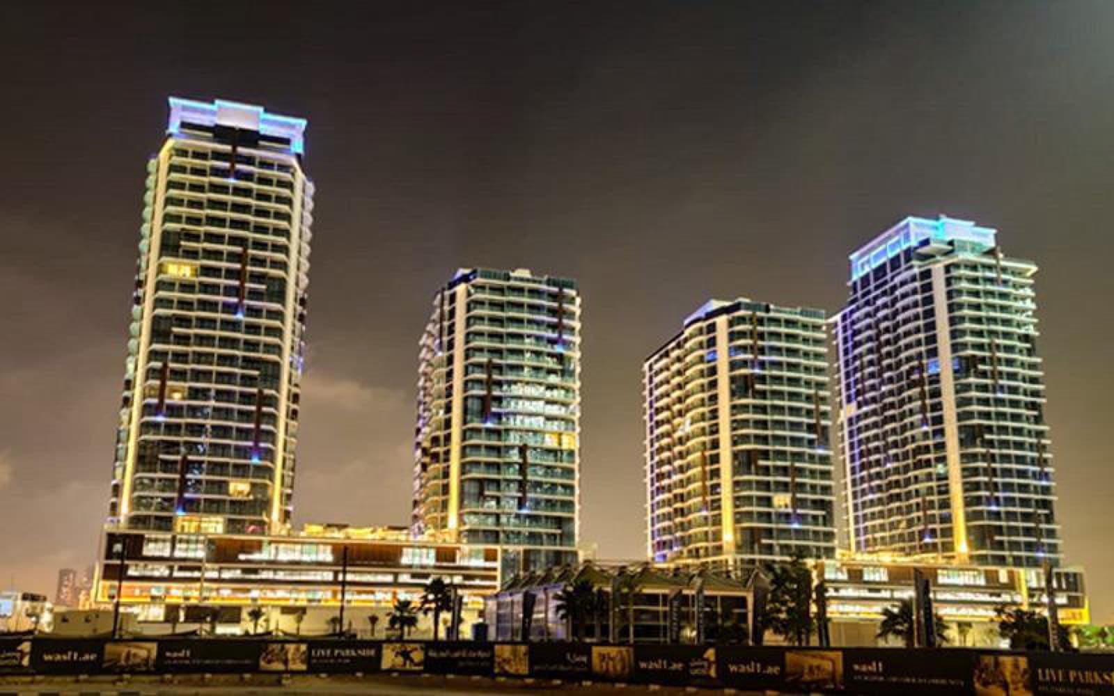 Kifaf development towers illuminated at night, Dubai